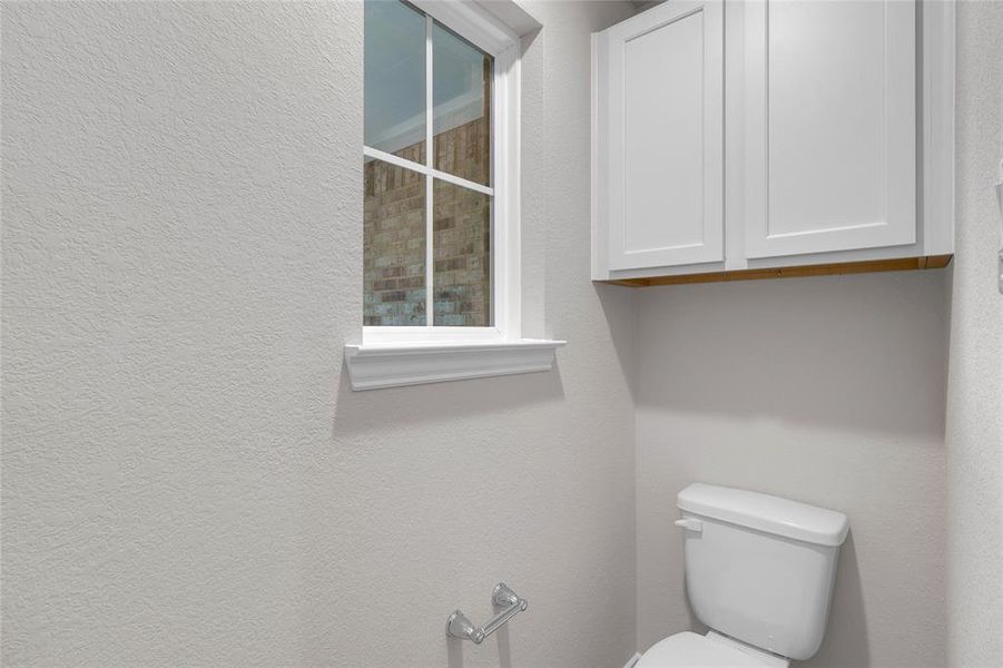 Primary restroom with cabinetry space for storage as well.