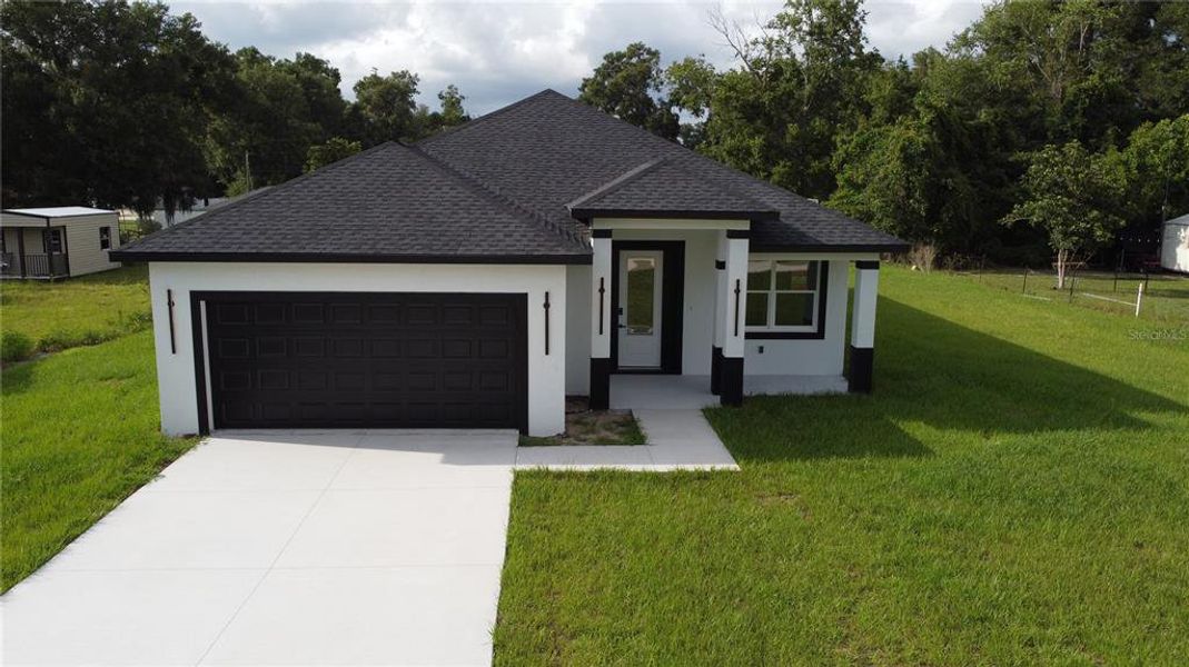 Front exterior of a new home in , Summerfield, FL, highlighting curb appeal (Image 28).