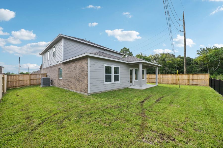 Front exterior of a new home in Heights of Barbers Hill, Mont Belvieu, TX, highlighting curb appeal (Image 1).