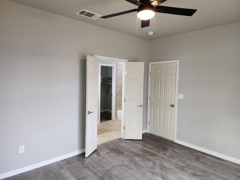 Empty room featuring ceiling fan and hardwood / wood-style flooring