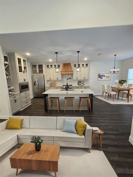 Living room featuring sink, a chandelier, and dark hardwood / wood-style flooring