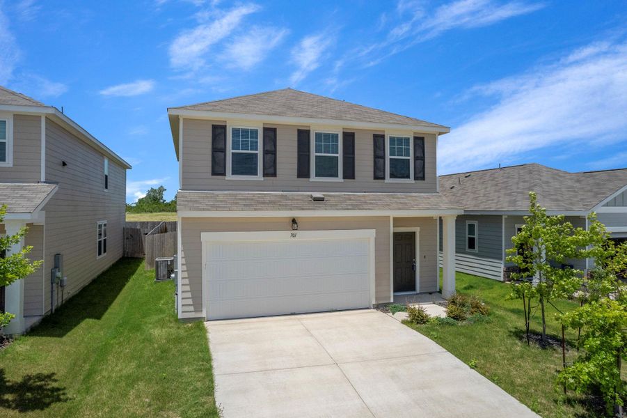 Front exterior of a new home in Cottonwood Farms, Hutto, TX, highlighting curb appeal (Image 18). Front exterior of a new home in Cottonwood Farms, Hutto, TX, highlighting curb appeal (Image 18).