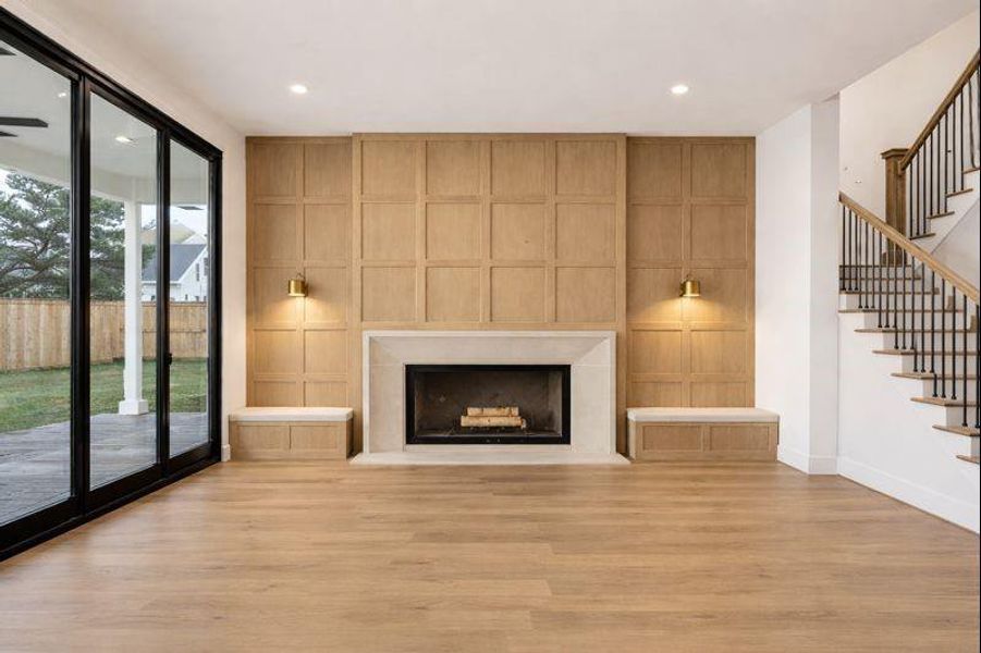 Spacious living room features large sliding glass door, ample windows, fireplace with stone surround, custom trim detail *this photo has been virtually rendered based on a previous home constructed by the builder. 1359 Wakefield may have different selections at builders sole discretion. These photos are not meant to be an exact representation of 1359 Wakefield.