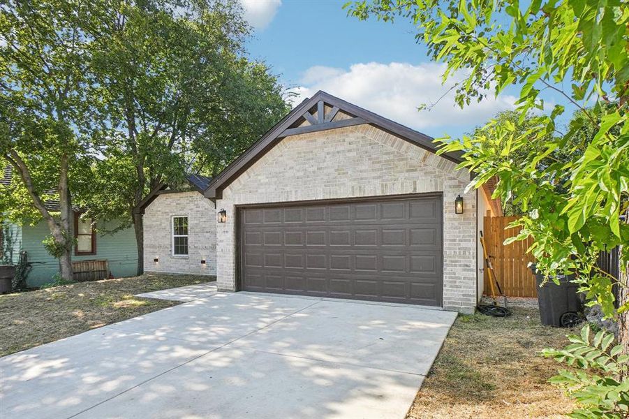 View of front of property with an attached garage, concrete driveway, and brick siding View of front of property with an attached garage, concrete driveway, and brick siding