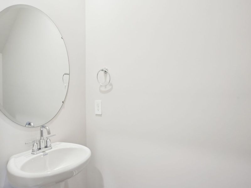 The half bathroom is conveniently located on the first floor for guests and visitors.