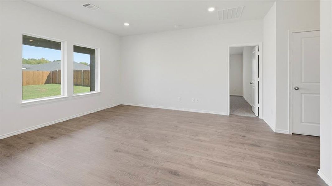 Empty room featuring light wood-style flooring and recessed lighting Empty room featuring light wood-style flooring and recessed lighting