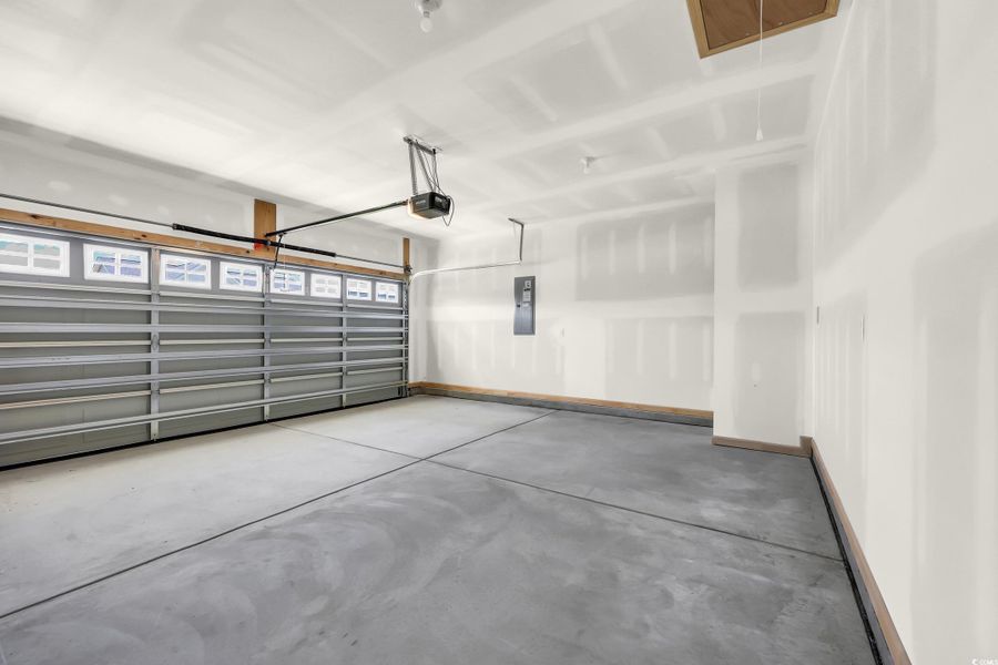Garage with electric panel and a garage door opener