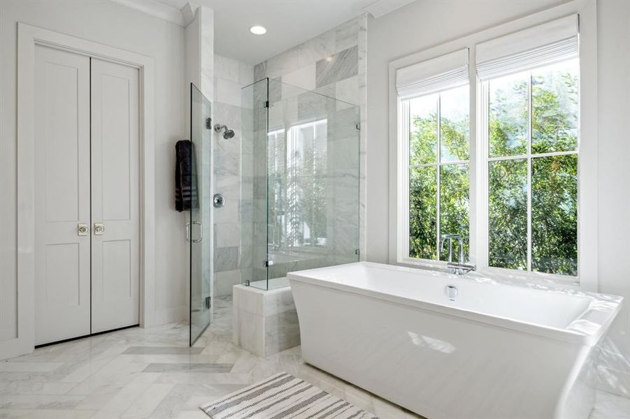 Full bathroom with recessed lighting, a freestanding tub, plenty of natural light, and a shower stall Full bathroom with recessed lighting, a freestanding tub, plenty of natural light, and a shower stall