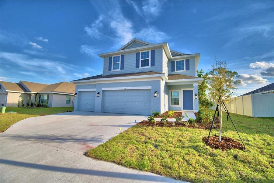 Front exterior of a new home in Horse Creek at Crosswinds, Davenport, FL, highlighting curb appeal (Image 2). Front exterior of a new home in Horse Creek at Crosswinds, Davenport, FL, highlighting curb appeal (Image 2).
