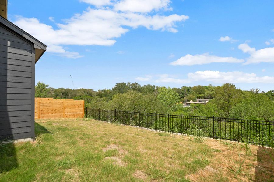 View of yard with a wooded view View of yard with a wooded view