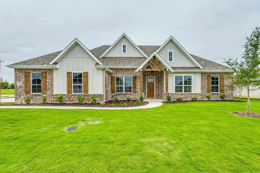 Representative exterior photo of a completed home built from the The Finley by Elmwood Custom Homes in Wooded Creek, Waxahachie, TX (Image 6).