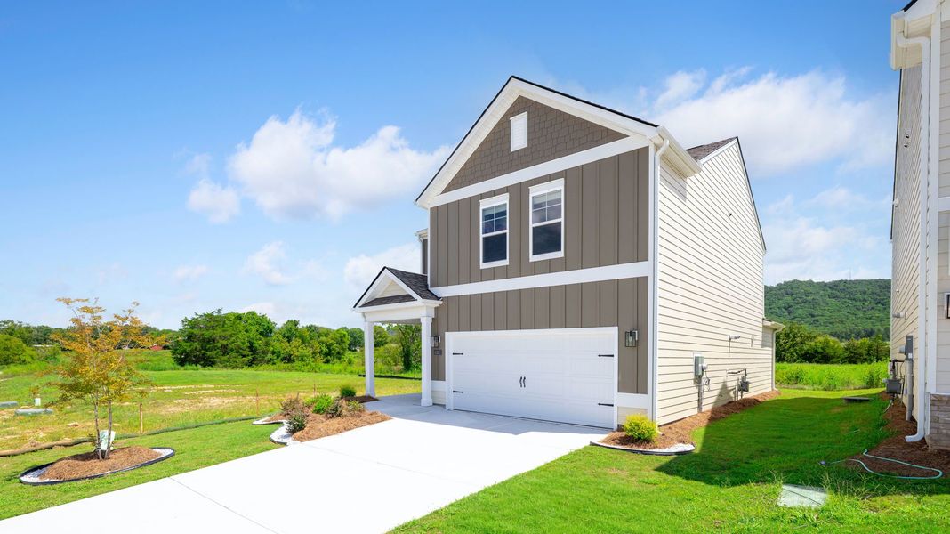 Front exterior of a new home in Harbor Crest, Ooltewah, TN, highlighting curb appeal (Image 21). Front exterior of a new home in Harbor Crest, Ooltewah, TN, highlighting curb appeal (Image 21).