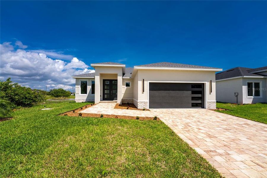 Front exterior of a new home in , Rotonda West, FL, highlighting curb appeal (Image 27).