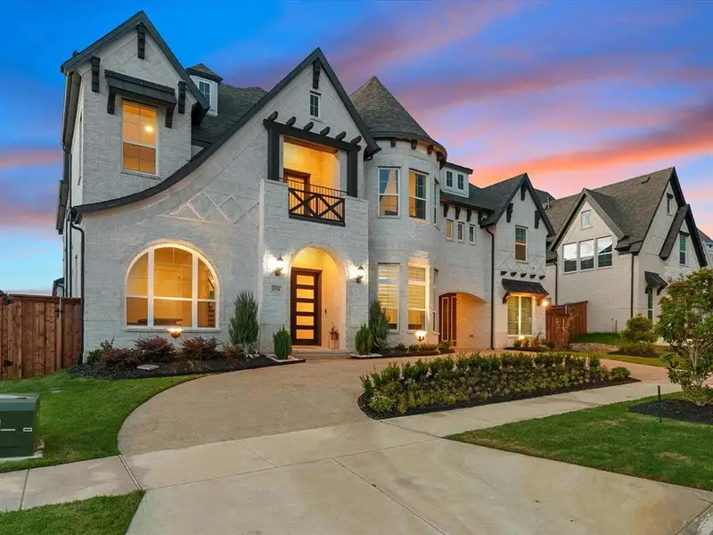 White brick exterior featuring gabled roofs and dark trim accents White brick exterior featuring gabled roofs and dark trim accents
