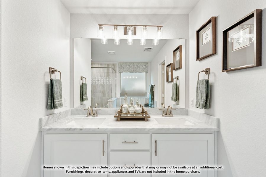 Bathroom with double sink vanity, white cabinets, marble countertop, and large mirror with overhead lighting Bathroom with double sink vanity, white cabinets, marble countertop, and large mirror with overhead lighting