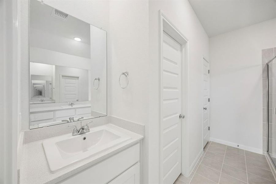 Primary Bathroom in the Cypress home plan by Trophy Signature Homes - REPRESENTATIVE PHOTO