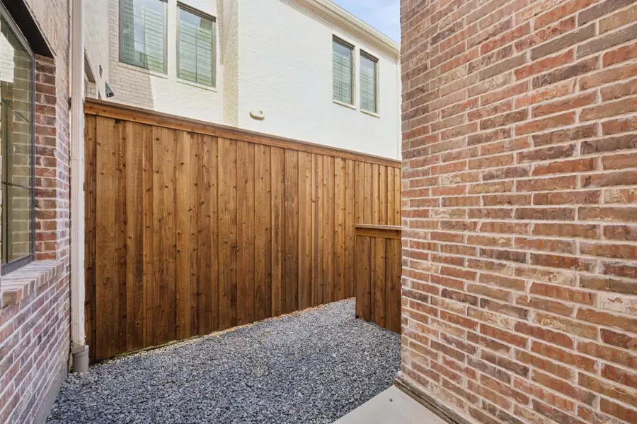Exterior details and patio area of a home in Newman Village Townhomes, Frisco (Image 3).