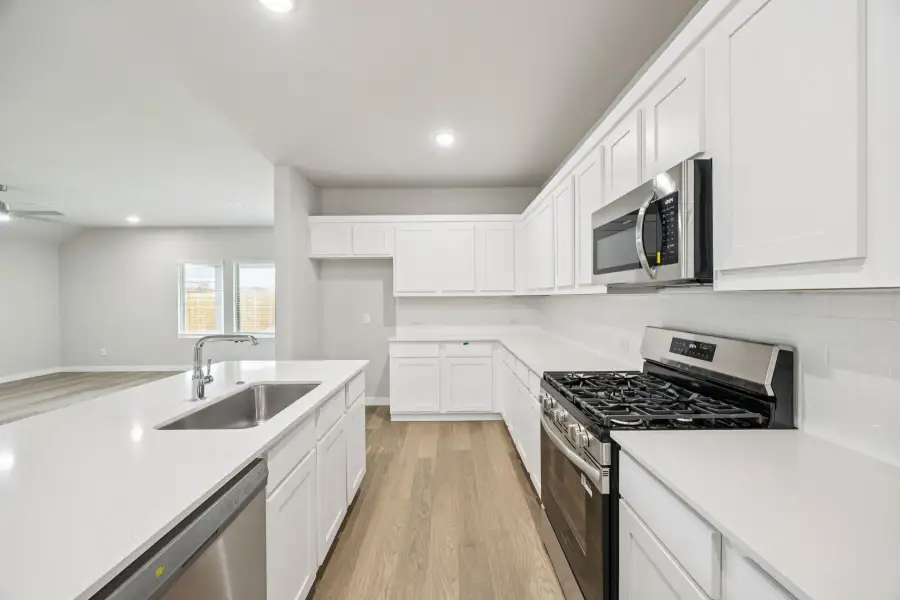 Kitchen in the Hayden home plan by Trophy Signature Homes – REPRESENTATIVE PHOTO