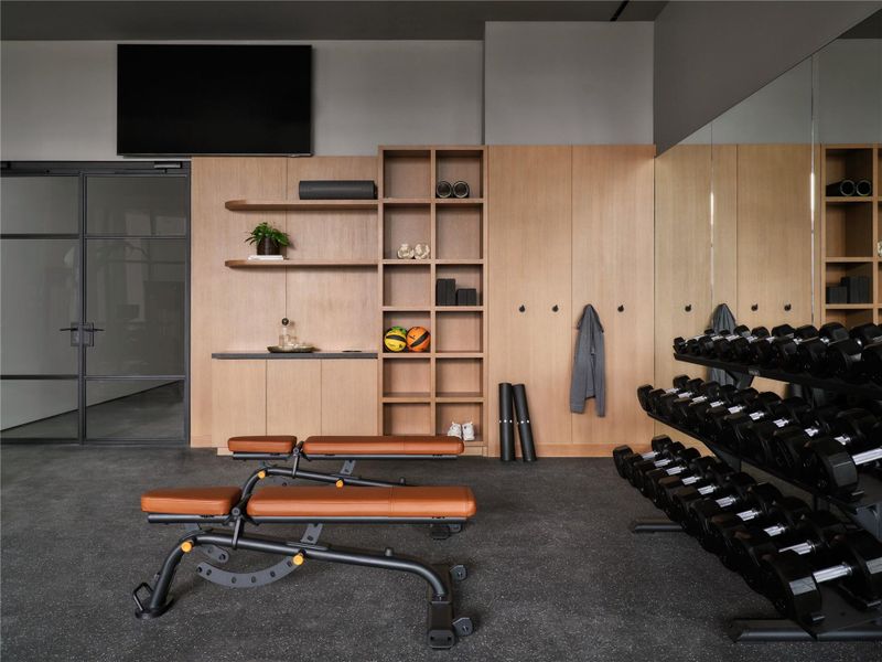 Custom oak cabinetry and seamless rubber flooring anchor this professionally designed home fitness space. Custom oak cabinetry and seamless rubber flooring anchor this professionally designed home fitness space.