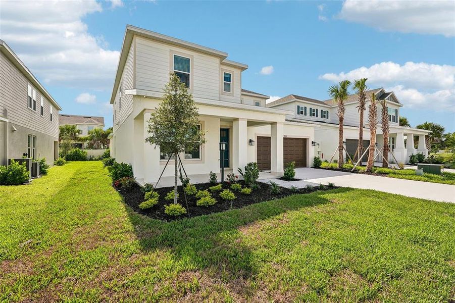 Front exterior of a new home in Tiburon, Nokomis, FL, highlighting curb appeal (Image 23).