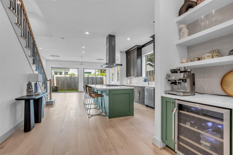 A convenient dry bar just off the kitchen adds extra functionality and makes entertaining effortless.