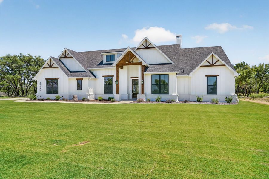 Front exterior of a new home in Timberview Preserves, Weatherford, TX, highlighting curb appeal (Image 23).