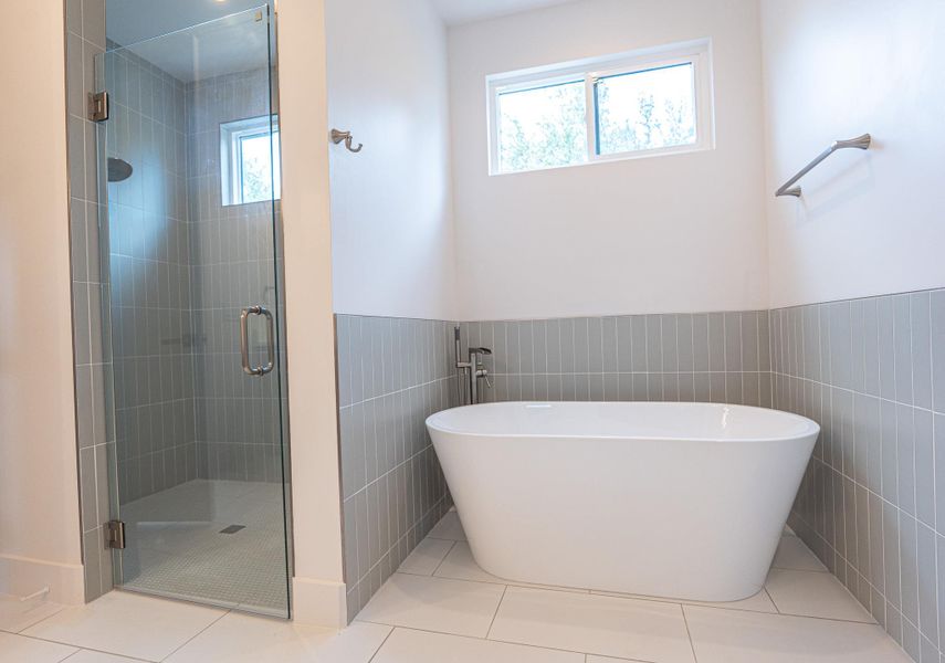 A modern bathroom boasts a spacious walk-in shower and a freestanding soaking tub for ultimate relaxation. A modern bathroom boasts a spacious walk-in shower and a freestanding soaking tub for ultimate relaxation.