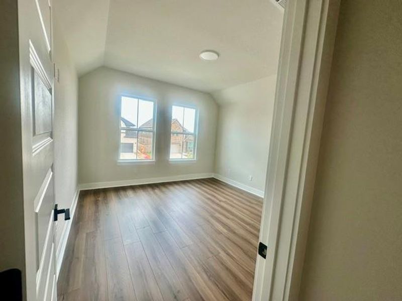 An inviting room boasts ample natural light and durable wood flooring. An inviting room boasts ample natural light and durable wood flooring.