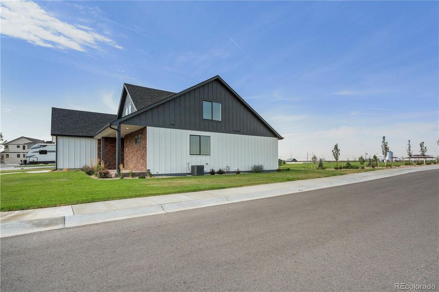 Front exterior of a new home in , Fort Morgan, CO, highlighting curb appeal (Image 21).