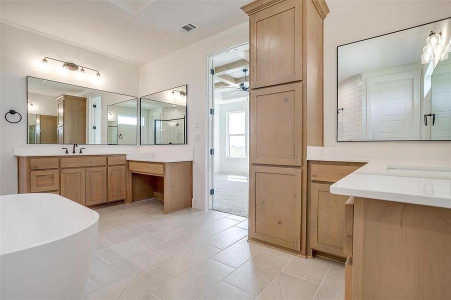 Bathroom featuring a bathtub, ceiling fan, beamed ceiling, vanity, and tile patterned floors