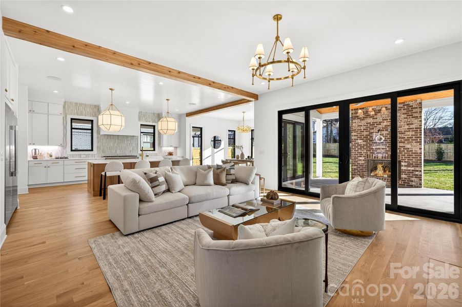 Living Room with Kitchen beyond. Glass doors open to Rear Porch. Gorgeous open space on Main Level!