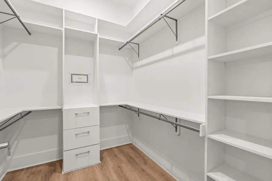 A thoughtfully appointed closet featuring tailored shelving and integrated storage, designed to bring structure, accessibility, and ease to everyday living.