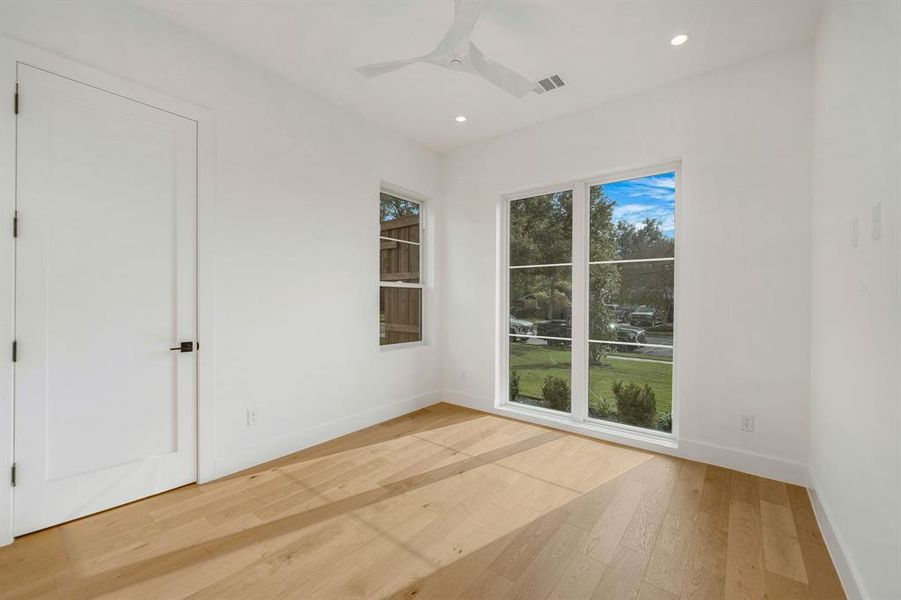 Empty room featuring light wood-type flooring, ceiling fan, and recessed lighting Empty room featuring light wood-type flooring, ceiling fan, and recessed lighting