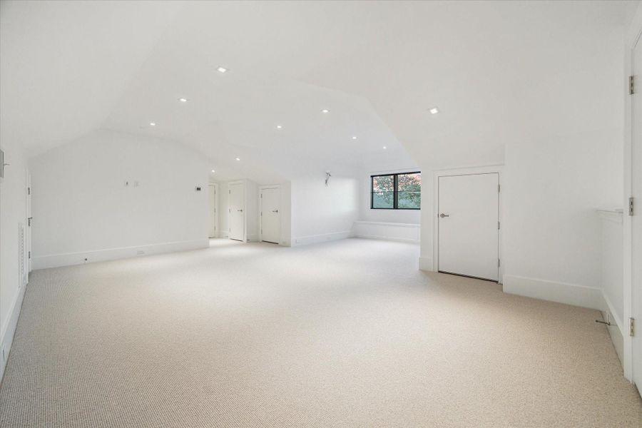 [Finished Third Floor Flexible Space]The fully-finished third floor features wool carpet, media plugs for a wall-mounted television, an inviting dormer window with window seat, and a full bath.