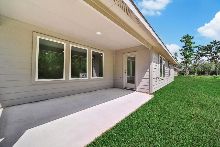 Front exterior of a new home in Williams Reserve East, Conroe, TX, highlighting curb appeal (Image 1).