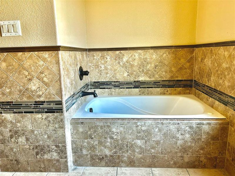 Bathroom featuring tiled bath