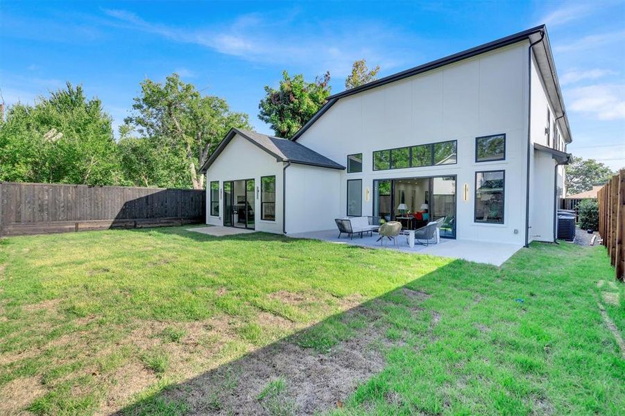 Rear view of property with a yard and a patio area