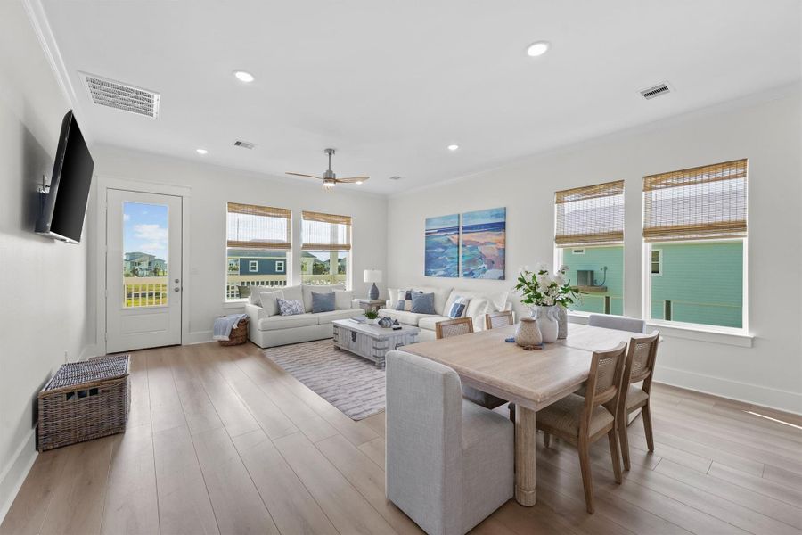 Enjoy seamless entertaining in this open-concept living space featuring oversized windows, modern lighting, and an expansive kitchen island. Enjoy seamless entertaining in this open-concept living space featuring oversized windows, modern lighting, and an expansive kitchen island.