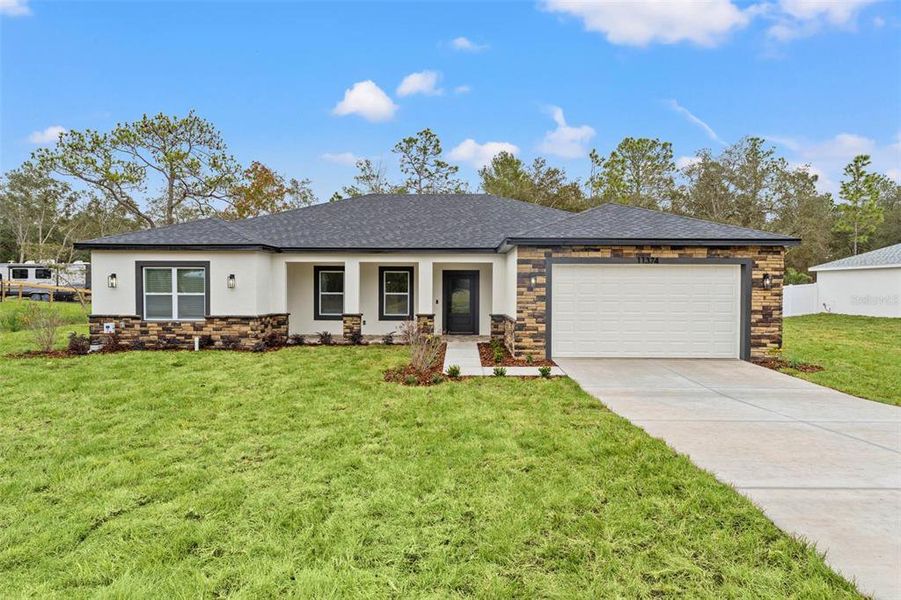 Front exterior of a new home in , Weeki Wachee, FL, highlighting curb appeal (Image 24). Front exterior of a new home in , Weeki Wachee, FL, highlighting curb appeal (Image 24).