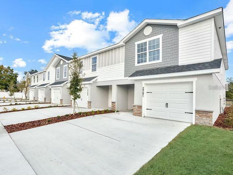 Front exterior of a new home in , Plant City, FL, highlighting curb appeal (Image 1). Front exterior of a new home in , Plant City, FL, highlighting curb appeal (Image 1).