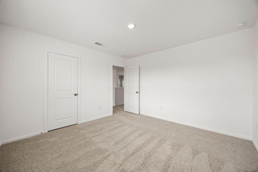 Generously sized with a large window and ample wall space, this bedroom offers comfort and flexibility for a variety of needs.