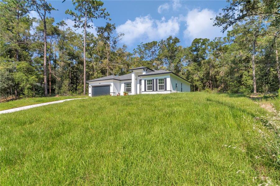 Front exterior of a new home in , Citrus Springs, FL, highlighting curb appeal (Image 17).