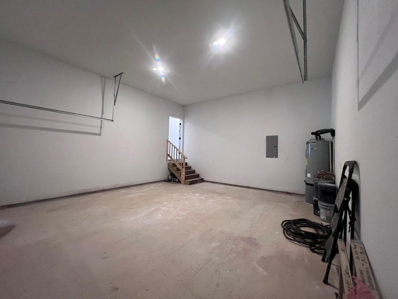 High ceilings and clean concrete floors define this spacious garage with stairs to the interior. High ceilings and clean concrete floors define this spacious garage with stairs to the interior.