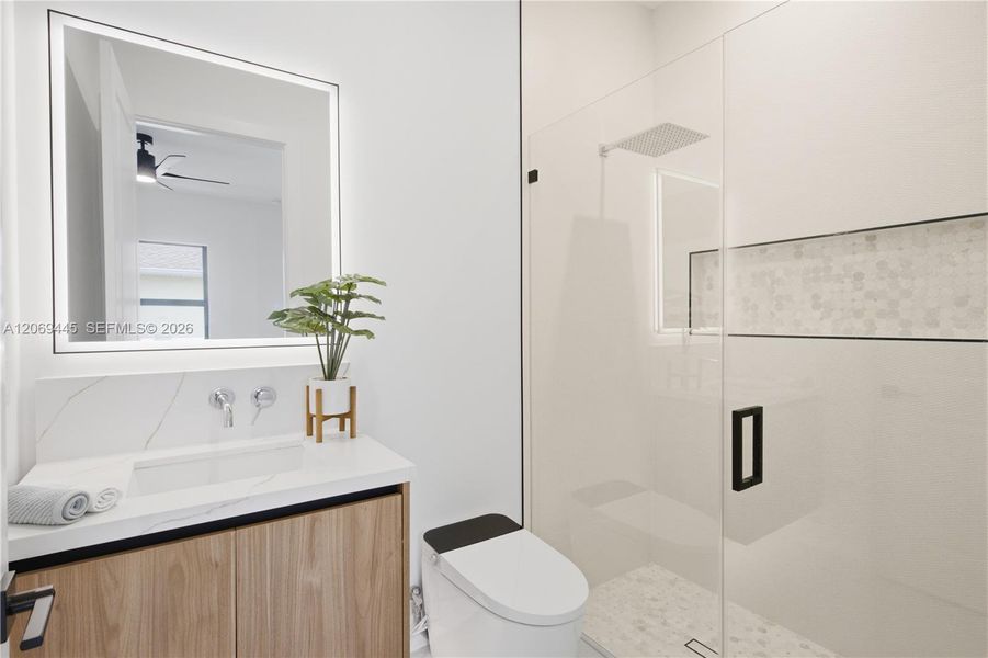 Private ensuite bathroom adds comfort and convenience to the second primary suite. Private ensuite bathroom adds comfort and convenience to the second primary suite.