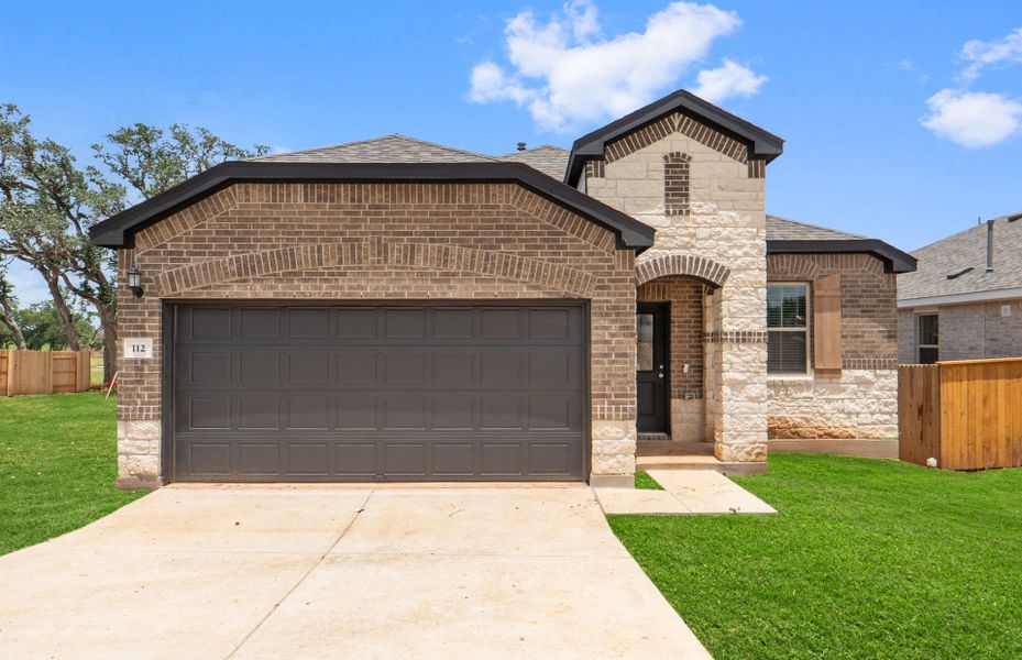Front exterior of a new home in La Cima, San Marcos, TX, highlighting curb appeal (Image 20).