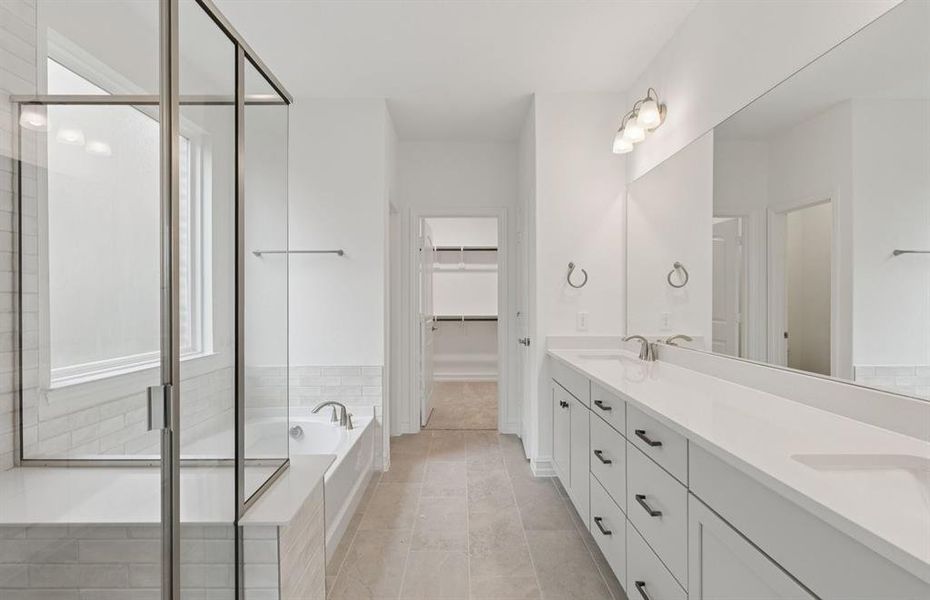 Owner's bath with double vanity and spacious shower  *Real home pictured