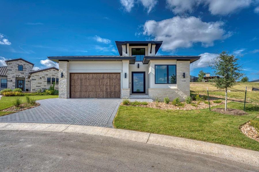 Modern architectural lines and stone accents define this striking contemporary home facade. Modern architectural lines and stone accents define this striking contemporary home facade.