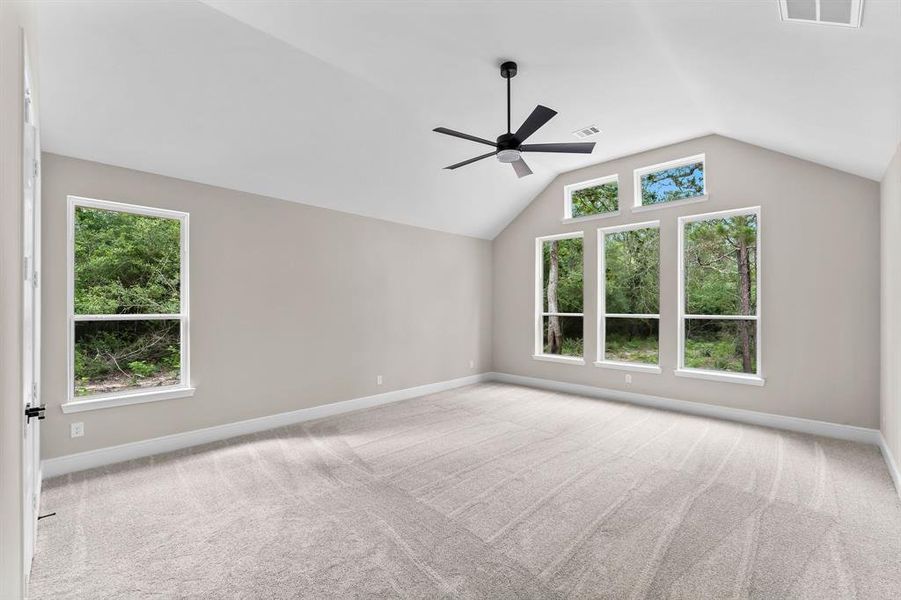 Huge primary bedroom with lots of natural light