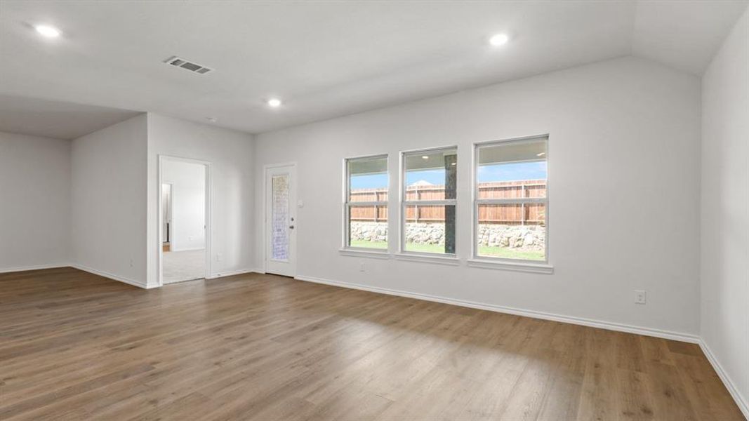 Empty room with wood finished floors and recessed lighting