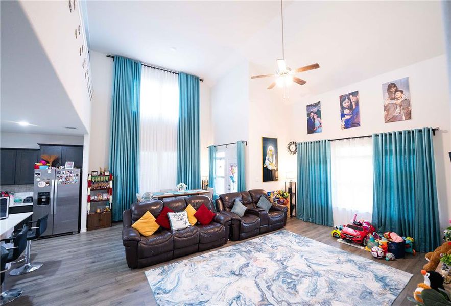 Vaulted ceilings featuring a ceiling fan, recessed lighting, and wood-finish flooring throughout Vaulted ceilings featuring a ceiling fan, recessed lighting, and wood-finish flooring throughout